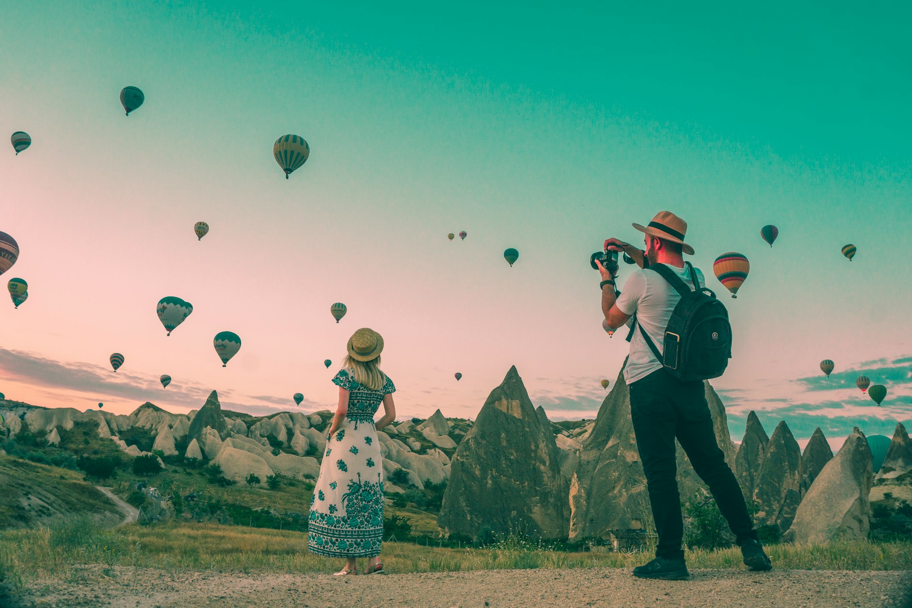 A couple watching hot-air balloons over Cappadocia